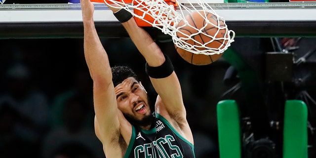 Boston Celtics' Jayson Tatum dunks against the Miami Heat during the first half of Game 6 of the NBA basketball playoffs Eastern Conference finals Friday, May 27, 2022, in Boston. (AP Photo/Michael Dwyer)