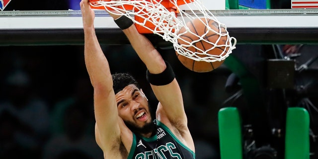 Boston Celtics' Jayson Tatum dunks against the Miami Heat during the first half of Game 6 of the NBA basketball playoffs Eastern Conference finals Friday, May 27, 2022, in Boston. (AP Photo/Michael Dwyer)