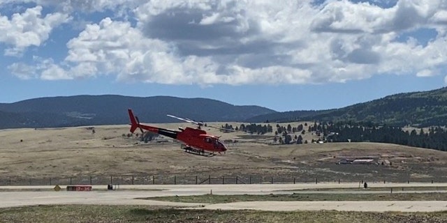 A helicopter launches on its way to deliver supplies to hotshot crews on New Mexico's Calf Canyon and Hermits Peak Fires.