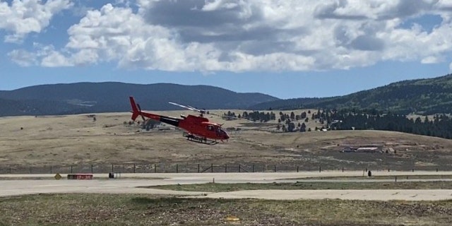 A helicopter launches on its way to deliver supplies to hotshot crews on New Mexico's Calf Canyon and Hermits Peak Fires.