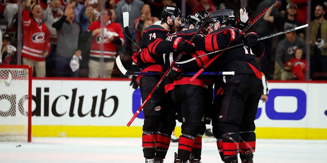 The Carolina Hurricanes celebrate a goal against the Boston Bruins during the first period of Game 2 of an NHL hockey Stanley Cup first-round playoff series in Raleigh, N.C., Wednesday, May 4, 2022.