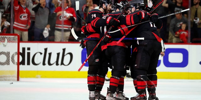The Carolina Hurricanes celebrate a goal against the Boston Bruins during the first period of Game 2 of an NHL hockey Stanley Cup first-round playoff series in Raleigh, N.C., Wednesday, May 4, 2022.