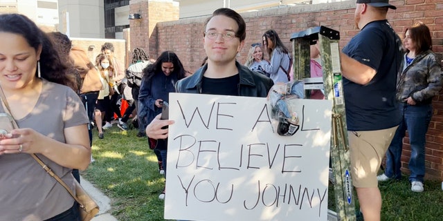 A Depp fan holds up a