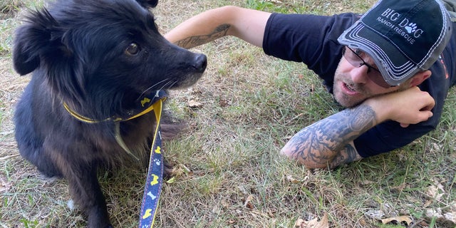 A Big Dog Ranch Rescue staffer embraces a dog who was displaced during Russia’s invasion of Ukraine.