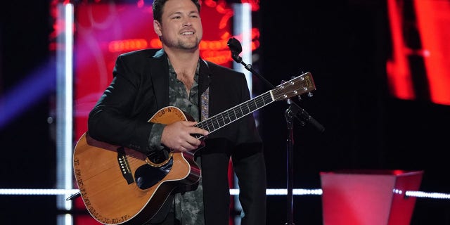 Ian Flanigan is shown performing on stage during an appearance on "The voice." "I always had the support of my hometown," he told Fox News Digital.