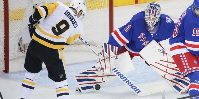 New York Rangers Goaltender Igor Shesterkin (31) makes a save on a shot by Pittsburgh Penguins Right Wing Evan Rodrigues (9) during game 7 of the first round of the NHL Stanley Cup Playoffs between the Pittsburgh Penguins and the New York Rangers on May 15, 2022 at Madison Square Garden in New York, NY.