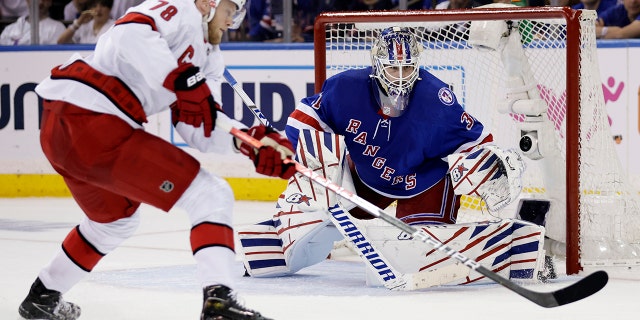 New York Rangers goaltender Igor Shesterkin, right, defends against Carolina Hurricanes center Steven Lorentz (78) during the second period of Game 3 of an NHL hockey Stanley Cup second-round playoff series, Sunday, May 22, 2022, in New York.