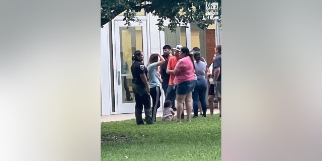 Parents wait to be reunited with their children in Uvalde.