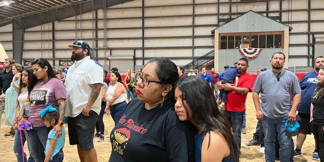 A mother and daughter attend the Uvalde, Texas candlelight vigil.