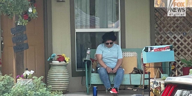 Woman sits outside home in Uvalde, Texas