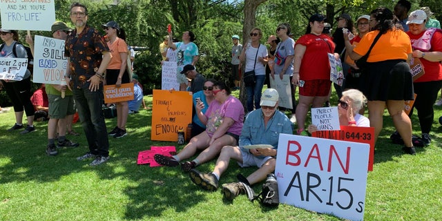 Protesters stand outside the NRA convention in Texas.
