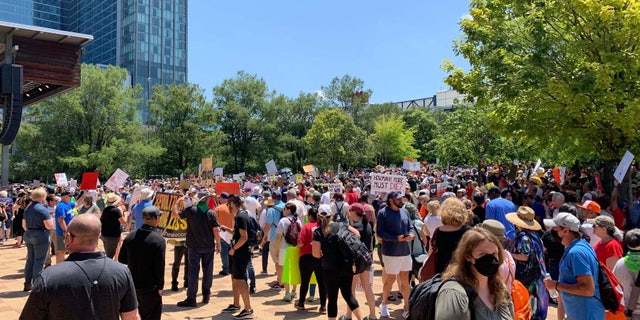 Protesters stand outside the NRA convention in Texas.