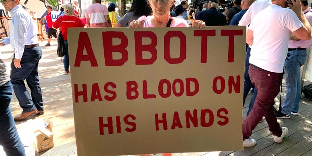 Houston resident Linda Bennett demonstrates outside the 2022 NRA convention in Texas.