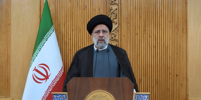 Iranian President Ebrahim Raishi speaks before departing Tehran's Mehrabad Airport for a trip to Oman, May 23, 2022. 