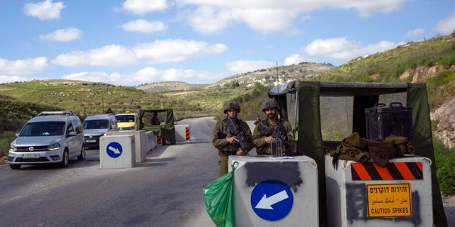 An Israeli army checkpoint controls the street leading to the West Bank city of Jenin April 12, 2022. 