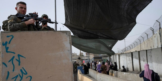 Israeli Border Police secure a checkpoint used by Palestinian to cross from the West Bank into Jerusalem, Friday, April 8, 2022.