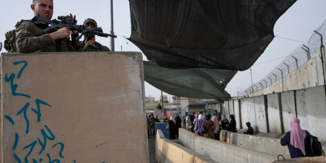 Israeli Border Police secure a checkpoint used by Palestinian to cross from the West Bank into Jerusalem, Friday, April 8, 2022.