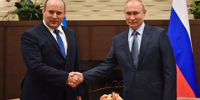 Russian President Vladimir Putin shakes hands with Israeli Prime Minister Naftali Bennett during their meeting, in Sochi, on Oct. 22 2021.