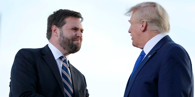 Senate candidate JD Vance greets former President Donald Trump at a rally at the Delaware County Fairgrounds, April 23, 2022, in Delaware, Ohio.