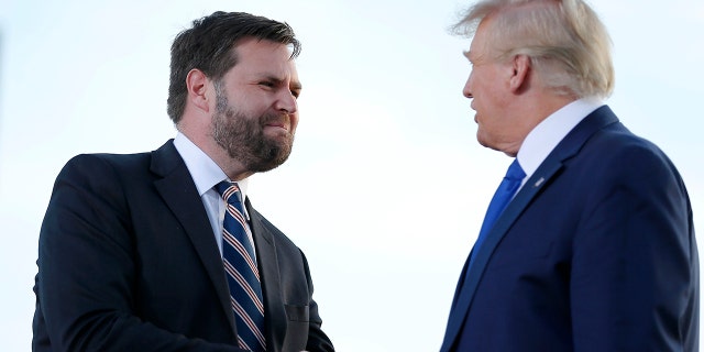 Senate candidate JD Vance greets former President Donald Trump at a rally at the Delaware County Fairground, April 23, 2022, in Delaware, Ohio.