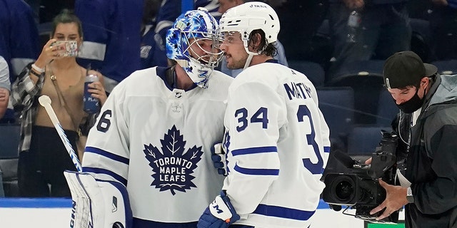 Toronto Maple Leafs goaltender Jack Campbell (36) and center Auston Matthews (34) celebrate after the team defeated the Tampa Bay Lightning during Game 3 of an NHL hockey first-round playoff series Friday, Mei 6, 2022, in Tampa, Fla. 