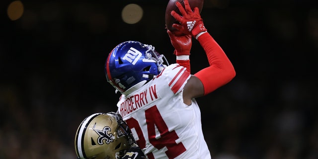 James Bradberry, number 24 of the New York Giants, intercepts the ball intended for Deonte Harris, number 11 of the New Orleans Saints, during a game at Caesars Superdome on October 3, 2021 in New Orleans, Louisiana.