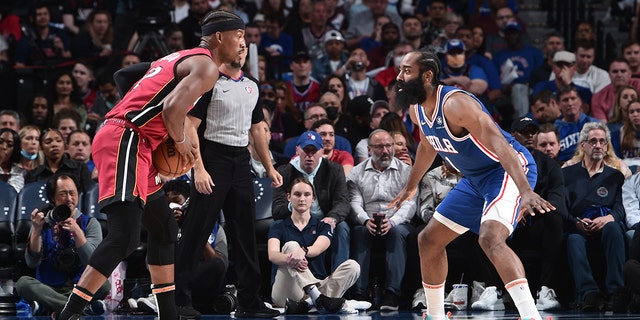 James Harden # 1 of the Philadelphia 76ers plays defense against Miami Heat's Jimmy Butler # 22 during the 6th game of the 2022 NBA Playoff Eastern Conference semifinals on May 12, 2022 at the Wells Fargo Center in Philadelphia, Pennsylvania.