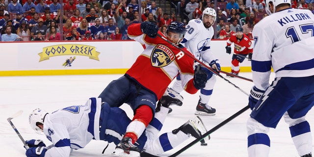 Tampa Bay Lightning defenseman Jan Rutta (44) takes down Florida Panthers left wing Jonathan Huberdeau as Lightning' Alex Killorn (17) and Nicholas Paul (20) watch during the second period of Game 2 of an NHL hockey second-round playoff series Thursday, May 19, 2022, in Sunrise, Fla.