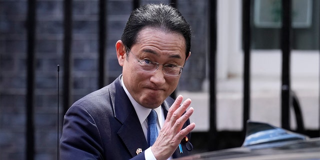 Japanese Prime Minister Fumio Kishida waves at the media as he leaves after his meeting with British Prime Minister Boris Johnson, at 10 Downing Street in London, Thursday, May 5, 2022. 