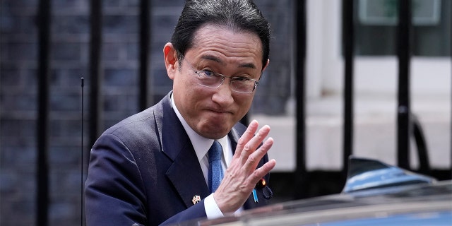 Japanese Prime Minister Fumio Kishida waves at the media as he leaves after his meeting with British Prime Minister Boris Johnson, at 10 Downing Street in London, Thursday, May 5, 2022.