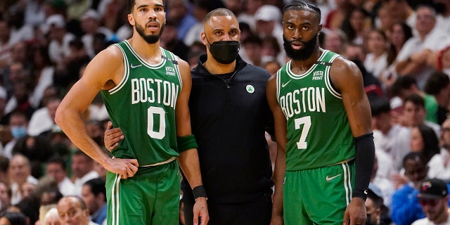 Boston Celtics head coach Ime Udoka speaks to Boston Celtics forward Jayson Tatum (0) and guard Jaylen Brown (7) during the second half of Game 1 of an NBA basketball Eastern Conference finals playoff series against the Miami Heat, Tuesday, May 17, 2022, in Miami.