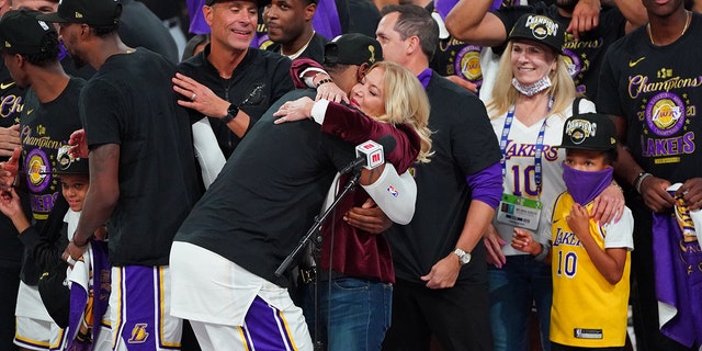 LeBron James hugs Jeanie Buss as the Los Angeles Lakers celebrate after winning Game Six of the NBA Finals against the Miami Heat on Oct. 11, 2020, in Orlando, Florida, at AdventHealth Arena.