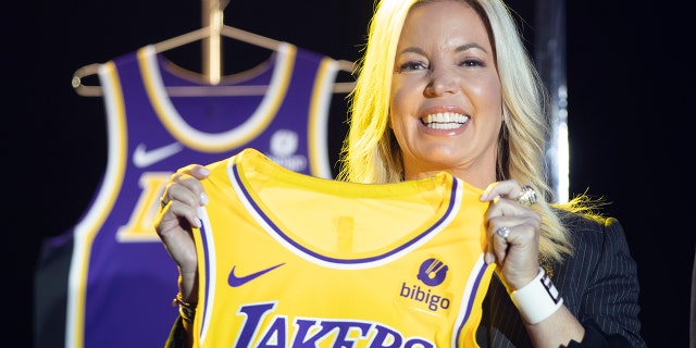 Jeanie Buss, co-owner of the Los Angeles Lakers, holds a new team jersey.