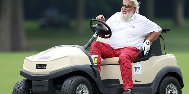 John Daly drives his cart to the 17th hole during the second round of the PGA Championship at Southern Hills Country Club on May 20, 2022, in Tulsa, Oklahoma.
