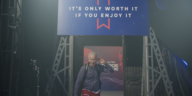 John McEnore enters the arena.