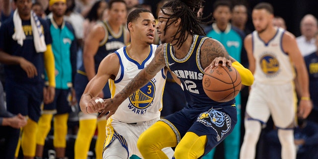 Memphis Grizzlies guard Ja Morant (12) is defended by Golden State Warriors guard Jordan Poole (3) during the first half of Game 2 of a second-round NBA playoff series May 3, 2022, in Memphis, Tenn.