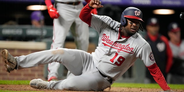Washington Nationals' Josh Bell scores on a single by Keibert Ruiz off Colorado Rockies relief pitcher Justin Lawrence in the ninth inning of a baseball game Tuesday, May 3, 2022, in Denver.