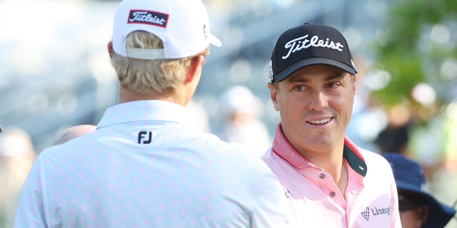 Justin Thomas of the United States and Will Zalatoris of the United States shake hands on the 13th tee, the first playoff hole, during the final round of the 2022 PGA Championship at Southern Hills Country Club on May 22, 2022 in Tulsa, Oklahoma.