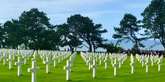 Gravestones at the Normandy American Cemetery in France stand in perfect alignment on a bluff overlooking the Atlantic Ocean. Many of the Americans buried here were killed on Omaha Beach, directly below, during the D-Day invasion on June 6, 1944. 