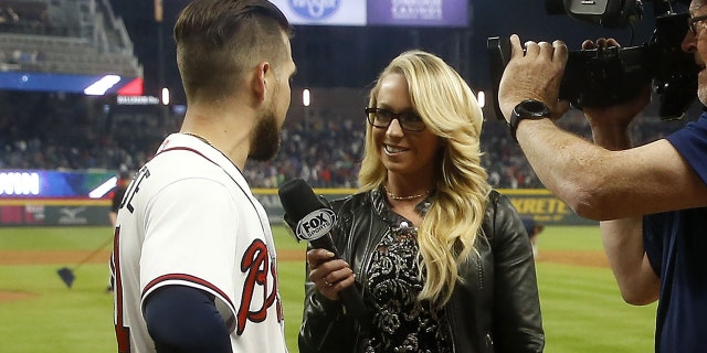 Centerfielder Ender Inciarte #11 of the Atlanta Braves is interviewed by Fox Sports South field reporter Kelsey Wingert after Inciarte's game winning squeeze bunt during the game against the New York Mets at SunTrust Park on April 21, 2018 in Atlanta, Georgia.