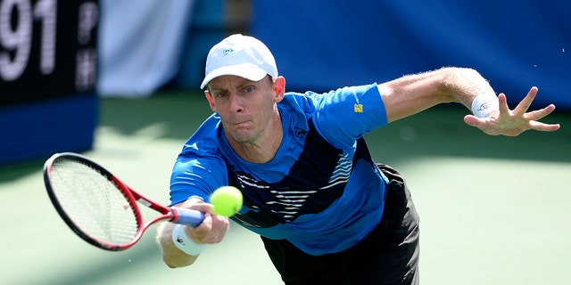 FILE - Kevin Anderson, of South Africa, reaches for a return  against Jenson Brooksby during a match in the Citi Open tennis tournament, on Aug. 2, 2021, in Washington.