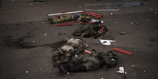 The bodies of unidentified men, believed to be Russian soldiers, arranged in a Z, a symbol of the Russian invasion, lie near a village recently retaken by Ukrainian forces on the outskirts of Kharkiv, Ukraine, on Monday, May 2.