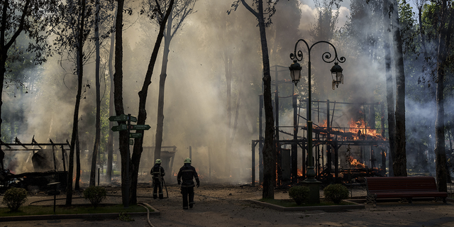 Firefighters extinguish a fire following a Russian bombardment at a park in Kharkiv, Ukraine, on Tuesday, May 3.