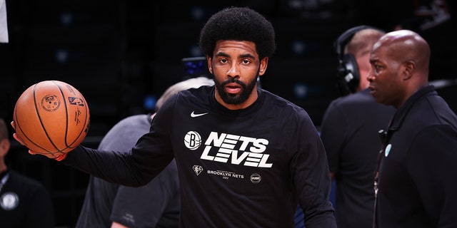 Kyrie Irving of the Brooklyn Nets warms up before a playoff game between the Brooklyn Nets and Boston Celtics at the Barclays Center in Brooklyn April 25, 2022. 