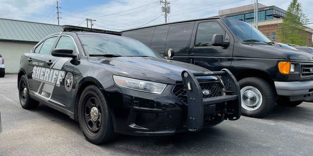 Vicky White’s marked car currently in a lot across from the Lauderdale County Courthouse. Inside in the cup holder is a half-empty Dasani water bottle, uncapped, and a few pairs of gloves.