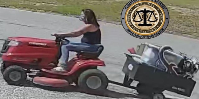 A woman riding an allegedly stolen lawnmower after stealing various from a home.