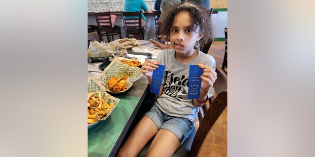 Layla Salazar, one of the victims of the mass shooting at Robb Elementary School in Uvalde, is seen posing with her two first place ribbons in this undated photo.