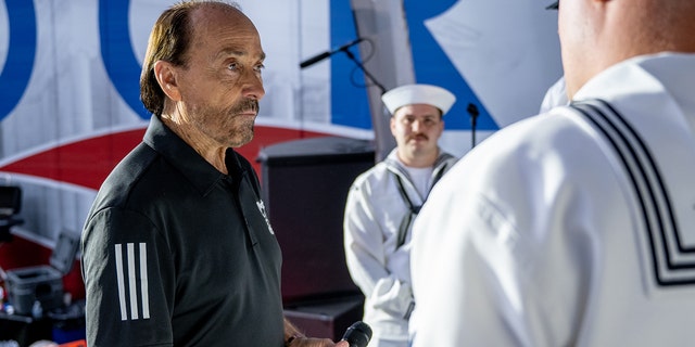 Lee Greenwood takes time to talk with members of the U.S. Navy during a visit to "Fox and Friends" at the Fox News Channel studios on May 27, 2022, in New York City. 