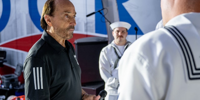 Lee Greenwood takes time to talk with members of the U.S. Navy during a visit to "Fox and Friends" at the Fox News Channel studios on May 27, 2022, in New York City. 