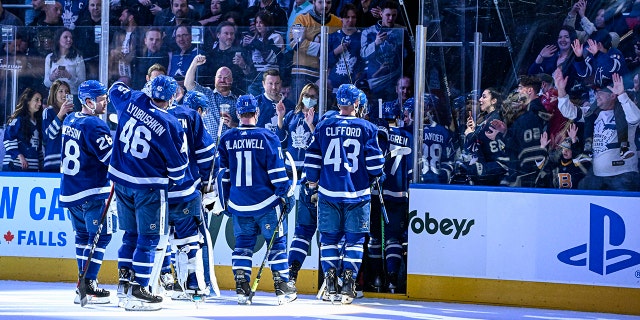 Toronto Maple Leafs fans cheer on the team as they exit the ice after defeating the Boston Bruins in an NHL hockey game in Toronto, Friday, April 29, 2022.